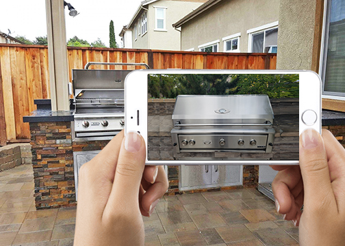 Phone taking a photo of a whole built-in grill with the lid closed