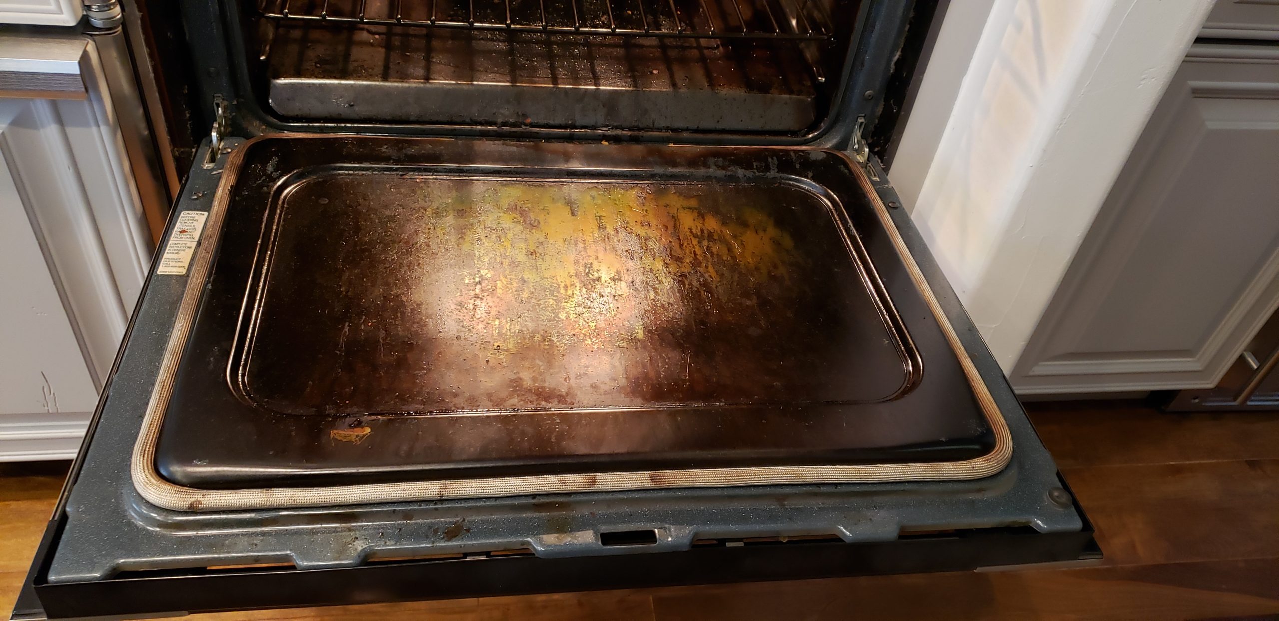 Oven door before cleaning